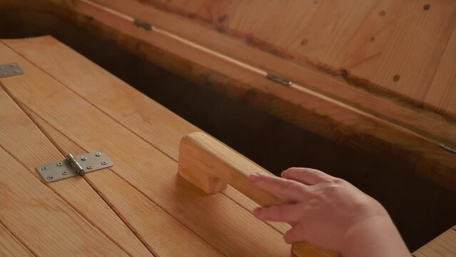Wooden sauna in spa. Phyto barrel is open. Cosmetologist begins wellness procedure. Closeup of cedar phyto barrel