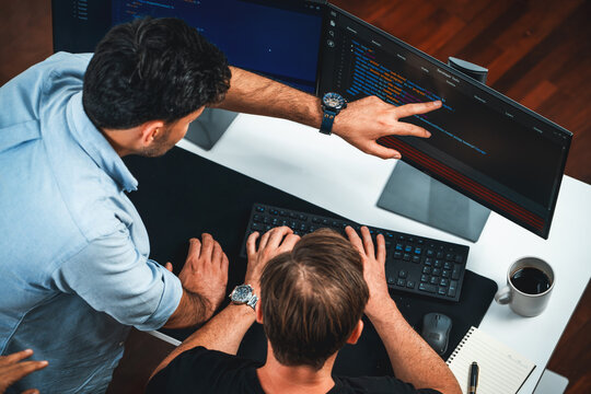 IT developers discussing online software development information on pc screen, creating program coding for latest version application on website. Concept of brainstorming firmware updated. Sellable.