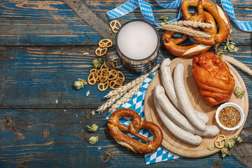 Traditional Oktoberfest set. Pretzels, beer, weisswurst, eisbein with mustard. German festival food