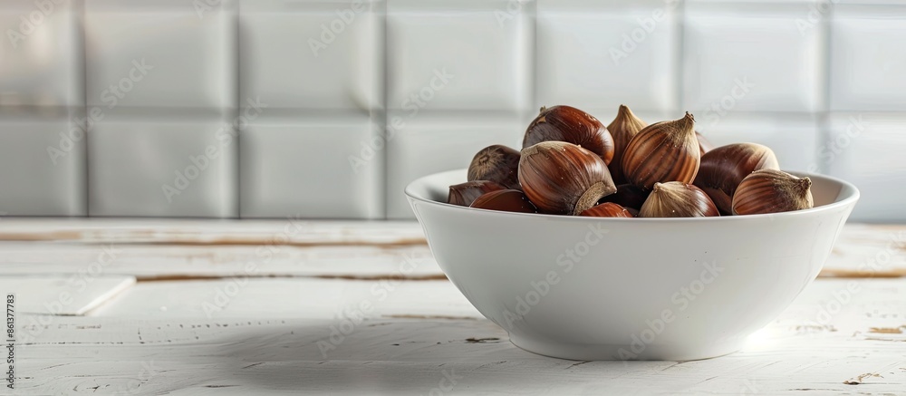 Aufkleber selective focus on a bowl of freshly boiled chestnuts on a white wooden table with room for text or 