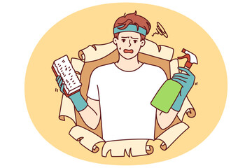 Disgruntled man with cleaning brush and bottle filled with chemical detergent that removes grease stains or dirt from furniture. Guy in casual clothes uses cleaning spray to do housework.