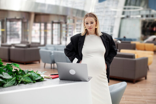 Powerful female empowerment featuring a strong, confident pregnant woman in a leadership or professional role, inspiring others with her strength and determination