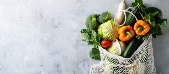 Mesh shopping bag filled with various vegetables like cabbage and zucchini, promoting healthy eating and sustainability with an ECO-friendly, reusable option showcasing a copy space image.