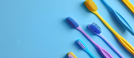 Flat lay with blue and purple toothbrushes, along with blue and yellow interdental brushes, showcasing the idea of natural dental care in a copy space image.