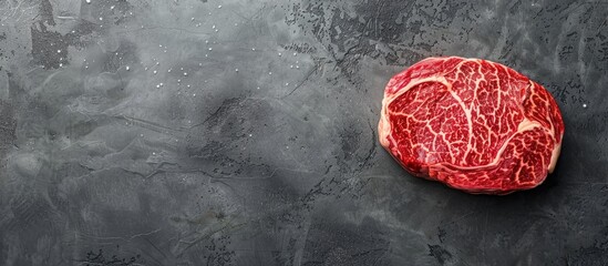 Top view of Japanese wagyu rib eye steak on a gray background, with a spacious copy space image.