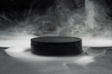 Black podium appearing from mysterious white smoke on a dark background