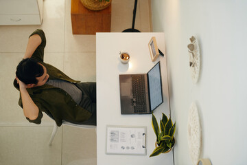 Top view of businessman working online on laptop at his workplace at office