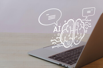 Laptop on table over white background with AI interface and speech bubble icon representing the integration of artificial intelligence in technology, digital innovation, and intelligent systems.