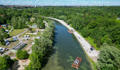 The Isar river flows into the city of Munich aerial view. Isar raft trips with Isar raft event
