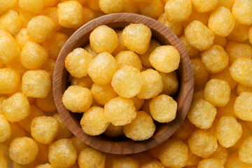 Corn balls in a wooden plate background. Top view