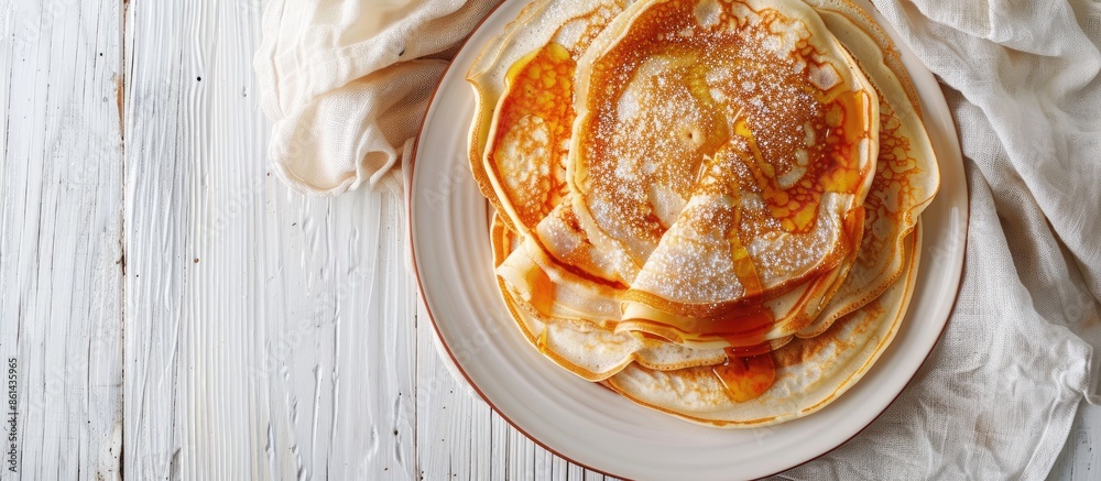 Poster close-up of delicious homemade caramel stuffed pancakes on a white wooden background with selective 