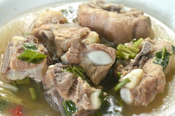 hot and spicy pork bone with tamarind and Thai herbs soup on plate