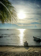 Sunset at Tioman beach, Malaysia with palm tree and wooden boat