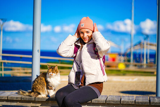 portrait of a woman with cat on the beach - Powered by Adobe