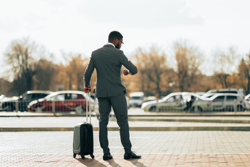 Airport Taxi. Businessman Waiting For Taxi Car, Looking At Watches