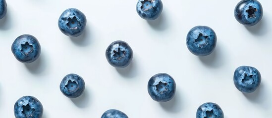 Blueberries arranged on a white surface with room for text; view from above. image with copy space