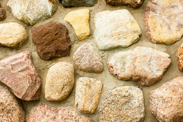 Stone wall of cobblestones. Natural stone wall.