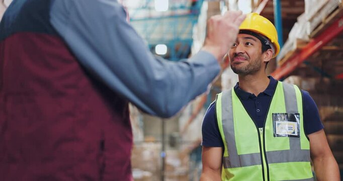 Man, logistic and talking with handshake in warehouse, engineer and agreement for partnership or shipping company. Professional, employee and industrial business, welcome and introduction or teamwork