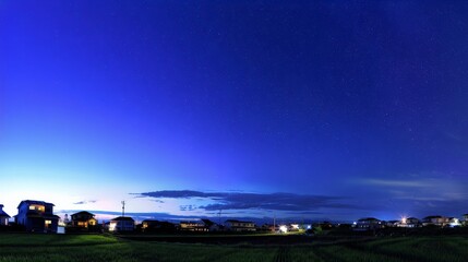 A serene night with stars and silhouetted houses