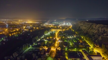 Fototapeta premium City lights illuminate a valley at night
