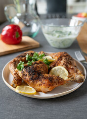 Delicious oven baked chicken legs ready to eat with garnish on a plate