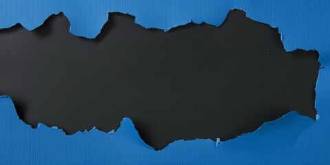 Torn paper background. An overhead view of blue torn paper revealing a black background for dramatic contrast. Ideal for announcements promotions