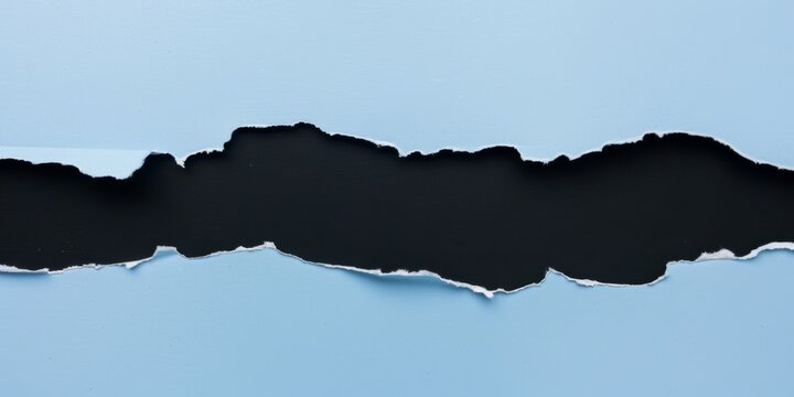 Torn paper background. An overhead view of blue torn paper revealing a black background for dramatic contrast. Ideal for announcements promotions