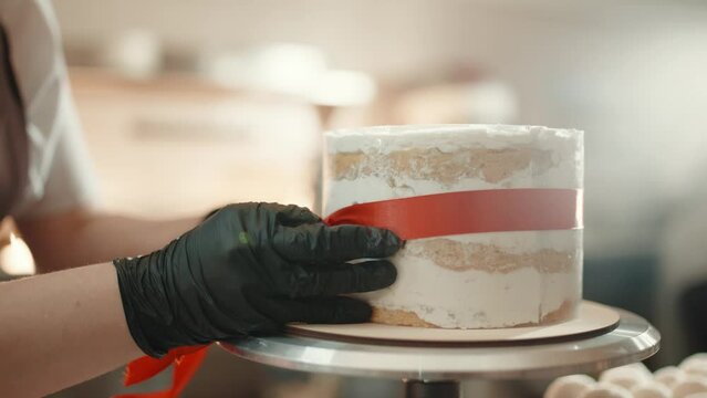 Woman making cake in kitchen, close-up. Female hands close up. Cake making process, Selective focus. 
