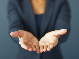 Close-up of a businesswoman's open hands extended forward, symbolizing offering, giving, or requesting assistance.