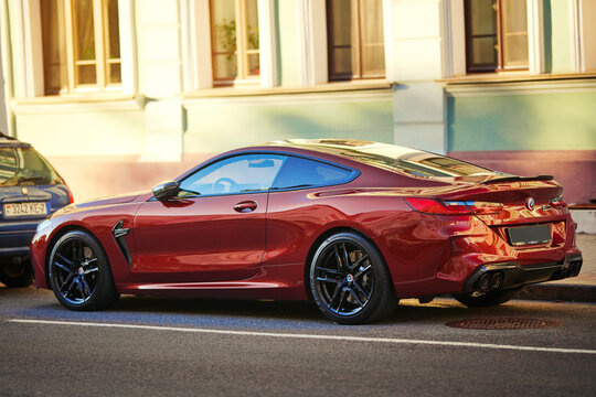 Minsk, Belarus. Jun 22, 2024. BMW M8 Coupe Competition Aventurine Red Metallic Colour parked at city street. BMW M8 Competition Coupe sports car parked at roadside..