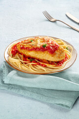 Chicken Parmesan, Italian pasta dish. Breaded chicken breast with cheese and spaghetti with tomato sauce, at a restaurant