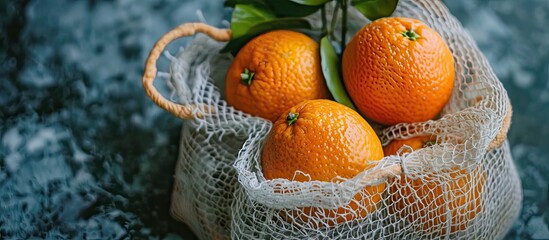 A picture of an orange in a mesh bag with copy space image.
