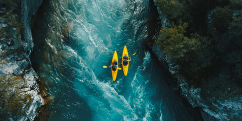 Aerial view of two kayakers navigating a mountain river