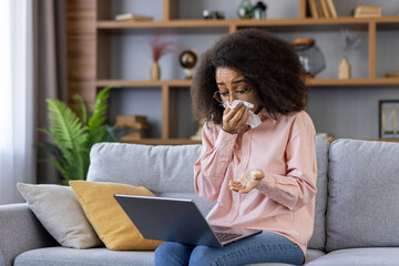 Woman crying during online consultation with psychologist using video call. Emotional moment of virtual therapy session. Shows comfort of home therapy for mental health support.