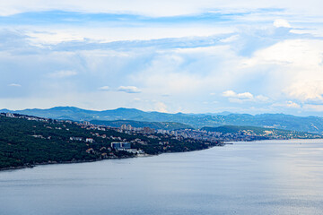 Opatija  Croatia - may 27 2024:  Coastal Cityscape With Blue Skies and Green Hills in Croatia