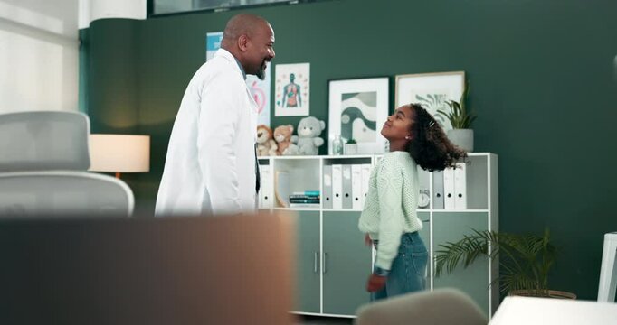 Doctor, girl and happy with play, dancing at clinic in office with bonding, connection and steps with rhythm. Black man, pediatrician and child with smile, funny dab and moving body in hospital