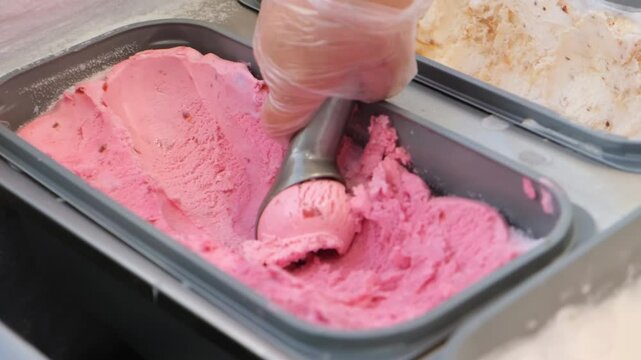 Close-up of the spoon slowly scooping frozen ice-cream gelato	
