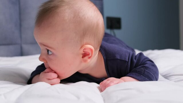 baby boy use teeth toy, sooth playtime. infant with yellow teether comfort childhood environment in nursery, rest moment