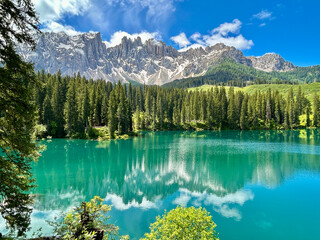 Fantastic view of Lago di Carezza lake or The Karersee with reflection of mountains in the dolomite alps, Dolomites, South Tyrol, Italy