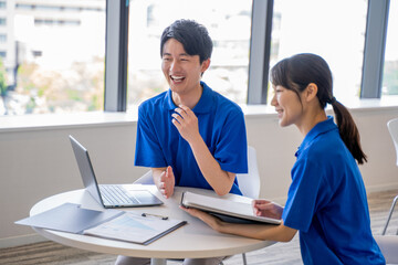 男女の介護士の打合せ