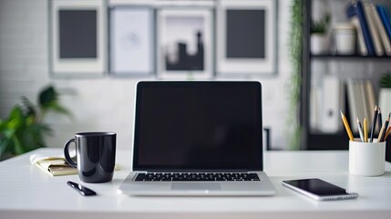 A white desk with a black coffee mug, a framed picture, a tablet, and a plant in a vase