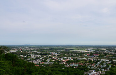 NAKHONSAWAN, THAILAND - JULY 1, 2024: High angle view, viewpoint of Nakhonsawan city and Thai Buddhist Temple with Blue sky with white cloud. Clear day and good weather in the morning.