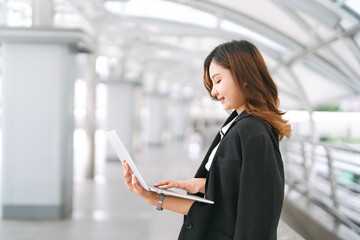 Business freelance woman busy using laptop computer at outdoor