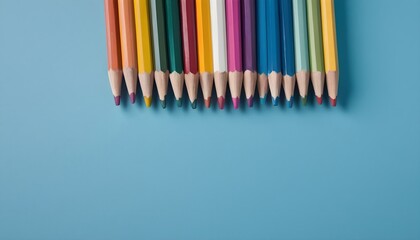 Blue background with color pencils and empty space for text, ideal for drawing and painting, a sharp and colorful row of pencils