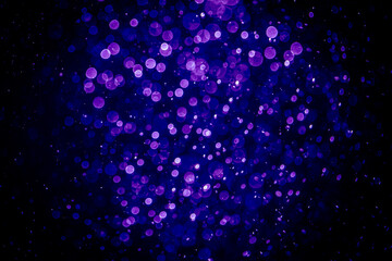 Blurred photo with purple violet and blue dots visible glittering, shining brightly look and feel luxurious