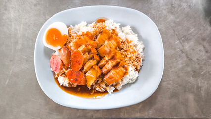 Crispy pork rice on a blue plate on the dining table