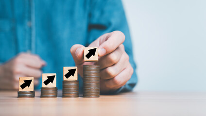 Business putting up arrow on the top of increasing coins stacking with copy space for Salary Increase, Insurance Cost up And Capital Rise concept.