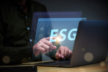 ESG environment social governance investment business concept, businessman using laptop with ESG icon.