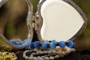 A jewelry box and various decorations. Necklace, beads.