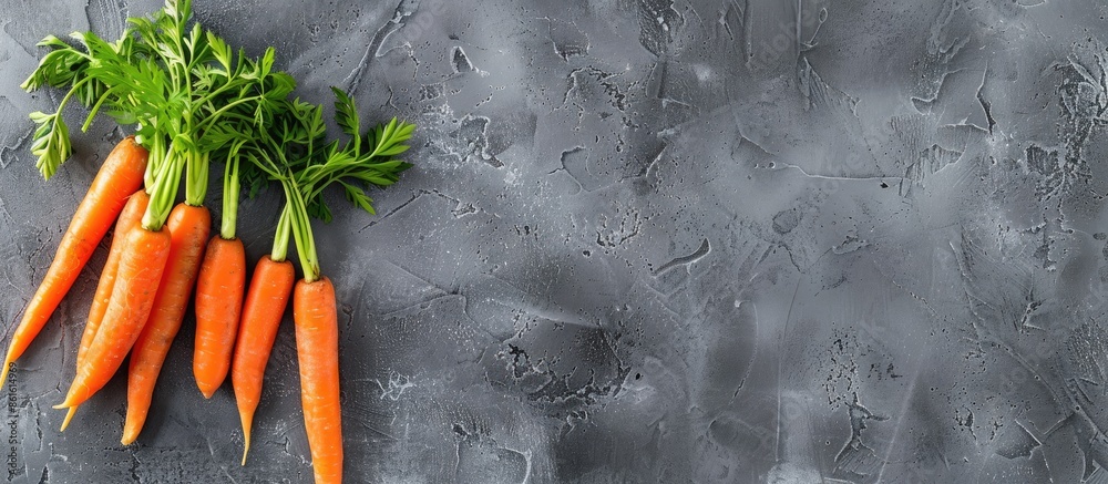 Leinwandbilder Top view of fresh carrots on a gray stone backdrop, with room for you to add text to the copy space image.